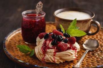 Homemade Pavlova dessert with raspberries and blueberries.