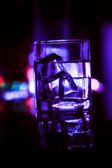 colored lighting of glasses in the night club bar