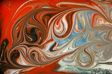 Gold marbling texture design. Red and golden marble pattern. Fluid art.