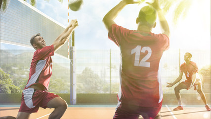 Professional volleyball players in action on the sunny day court