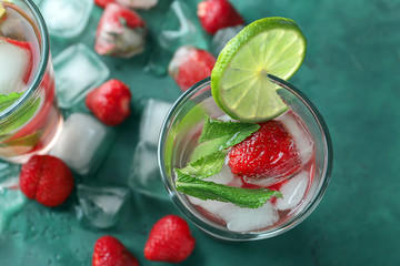 Glass with strawberry mojito on table