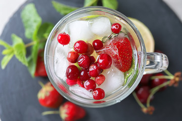 Glass cup with strawberry mojito on table, top view