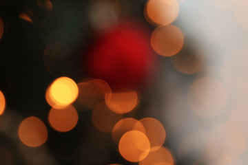 Blurred view of glowing Christmas lights, closeup