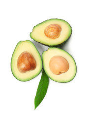 Halves of ripe avocados on white background