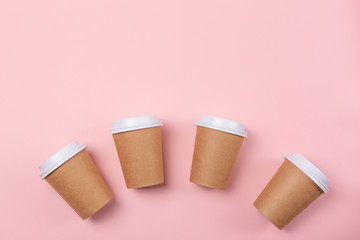 A cardboard cups of coffee or tea.