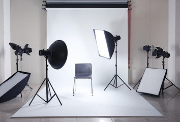 Modern chair in photo studio with professional equipment