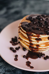 Stack of delicious homemade pancakes with sauce