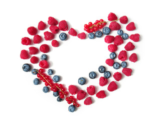 Heart made of delicious ripe berries on white background