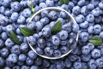 Bowl with fresh ripe blueberries, top view