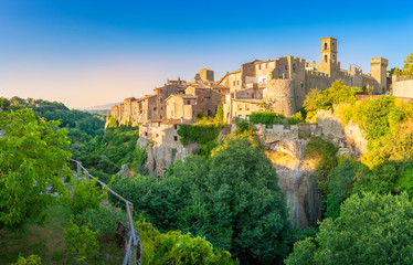 Panorama of the medieval town of Viturchiano located on the edge of the cliff, at sunset, Lazio....