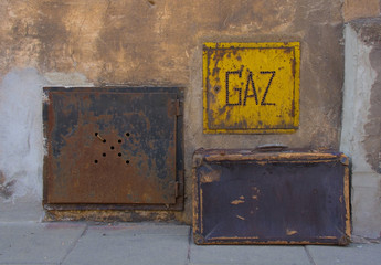 An old suitcase next to a gas access box in a street of residential buildings in the Podgorse area...