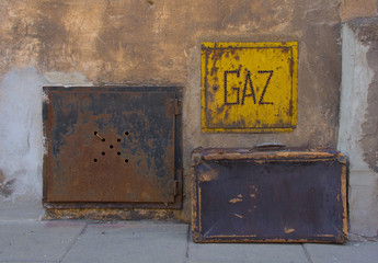 An old suitcase next to a gas access box in a street of residential buildings in the Podgorse area of Krakow, Poland. The area was the Jewish Ghetto during World War II
