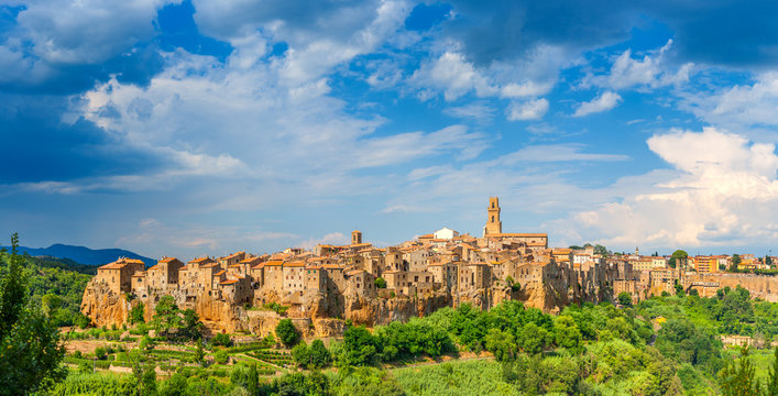 Panorama of the medieval town of Pitigliano located on the edge of the cliff, with beautiful clouds in the sky, Tuscany. Italy. Europe