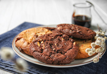 Plate with tasty cookies on table, closeup
