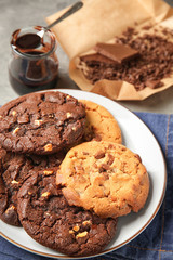 Plate with tasty cookies on table