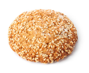 Tasty cookie with sesame seeds on white background