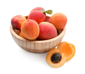 Bowl with ripe sweet apricots on white background