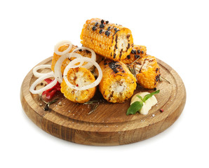 Wooden board with delicious grilled corn on white background