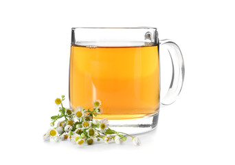 Glass cup of camomile tea on white background