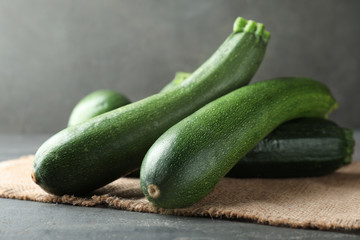 Ripe zucchinis on grey table, closeup