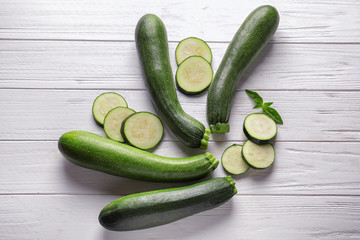 Ripe zucchinis on white wooden table