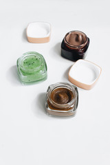 Assortment of different jams in small jars on white background