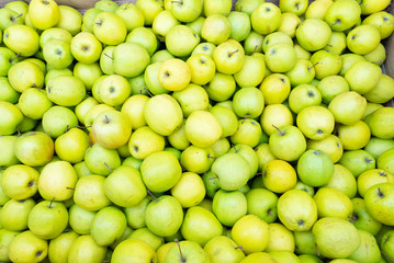 green apples background in box at street market