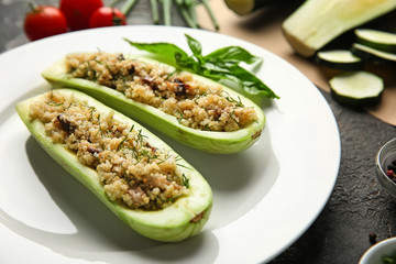 Quinoa stuffed zucchini boats on plate, closeup