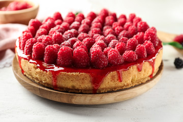 Delicious raspberry cheesecake on table, closeup