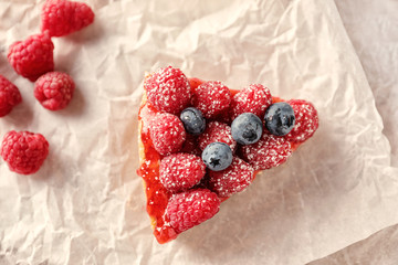 Piece of delicious raspberry cheesecake on table