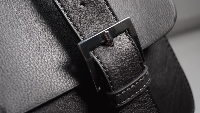 Detail from a black handbag. Eco leather, artificial leather, leather woman bag.