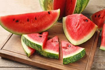 Sweet watermelon slices on wooden board