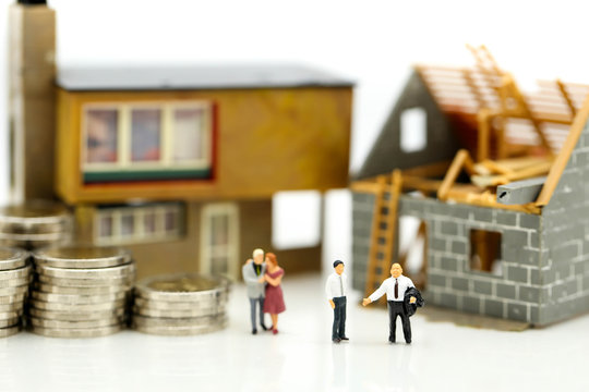 Miniature people : Business meeting with coins stack and home renovating,Business planning and Financial Concept.