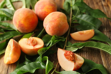 Fresh peaches on wooden table, closeup