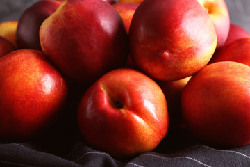 Fototapeta na wymiar Fresh peaches on napkin, closeup