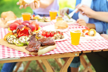 Family having picnic on summer day, closeup