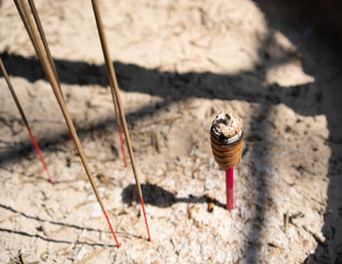 Closeup view of burning incense sticks in a censer in a taoist temple in Taiwan