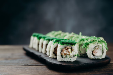 Japanese cuisine, professional culinary, seafood, restaurant menu, food photo art. Delicious sushi rolls set served on wooden tray