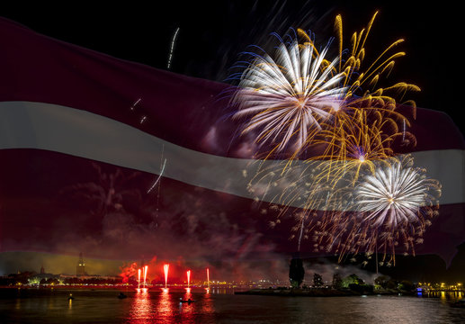 Conceptual collage image symbolizing 100 years of Latvian State Independence. Flag of Latvia on background of festive firework above old Riga