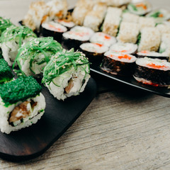 Japanese restaurant menu photo, traditional cuisine, delicious seafood, food art.  Appetizing assortment of maki sushi rolls, close up