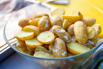 Cut raw potatoes in the glass bowl