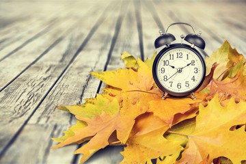 Retro alarm clock on table background