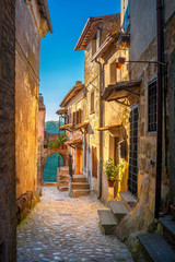 A street in a beautiful small medieval village in Tuscany at sunset. Italy. Europe - obrazy, fototapety, plakaty