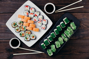 Sushi restaurant menu, Japanese traditional food. Tasty appetizing rolls set with wide assortment of fillings, flat lay.
