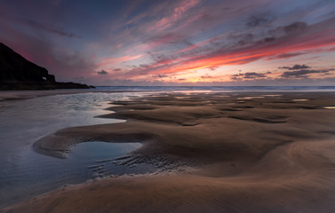 Fototapeta na wymiar Tidal Channel at Sunset, Perran Sands, Cornwall