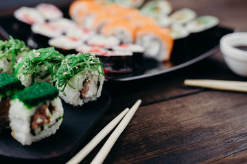 Japanese diet, seafood, property nutrition. Appetizing sushi rolls set on plate, selective focus