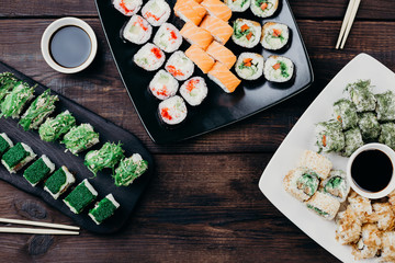 Japanese seafood, restaurant menu photo. Great appetizing sushi set, food art. Variety of delicious rolls served on plates, closeup.