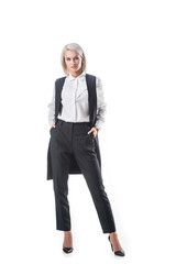 young stylish businesswoman in formal wear with hands in pockets isolated on white