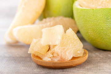fresh and peeled pomelo(shaddock), grapefruit with slices on wooden table background
