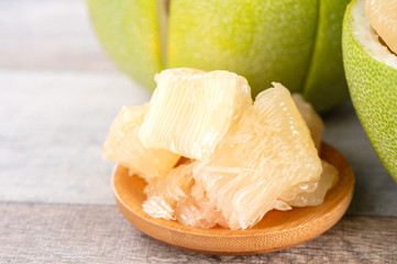 fresh and peeled pomelo(shaddock), grapefruit with slices on wooden table background